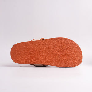 Close-up of a brown sandal sole on a light gray background