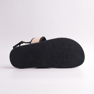 Close-up of a brown sandal sole on a light gray background