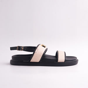 Brown sandal with beige strap on a light gray background
