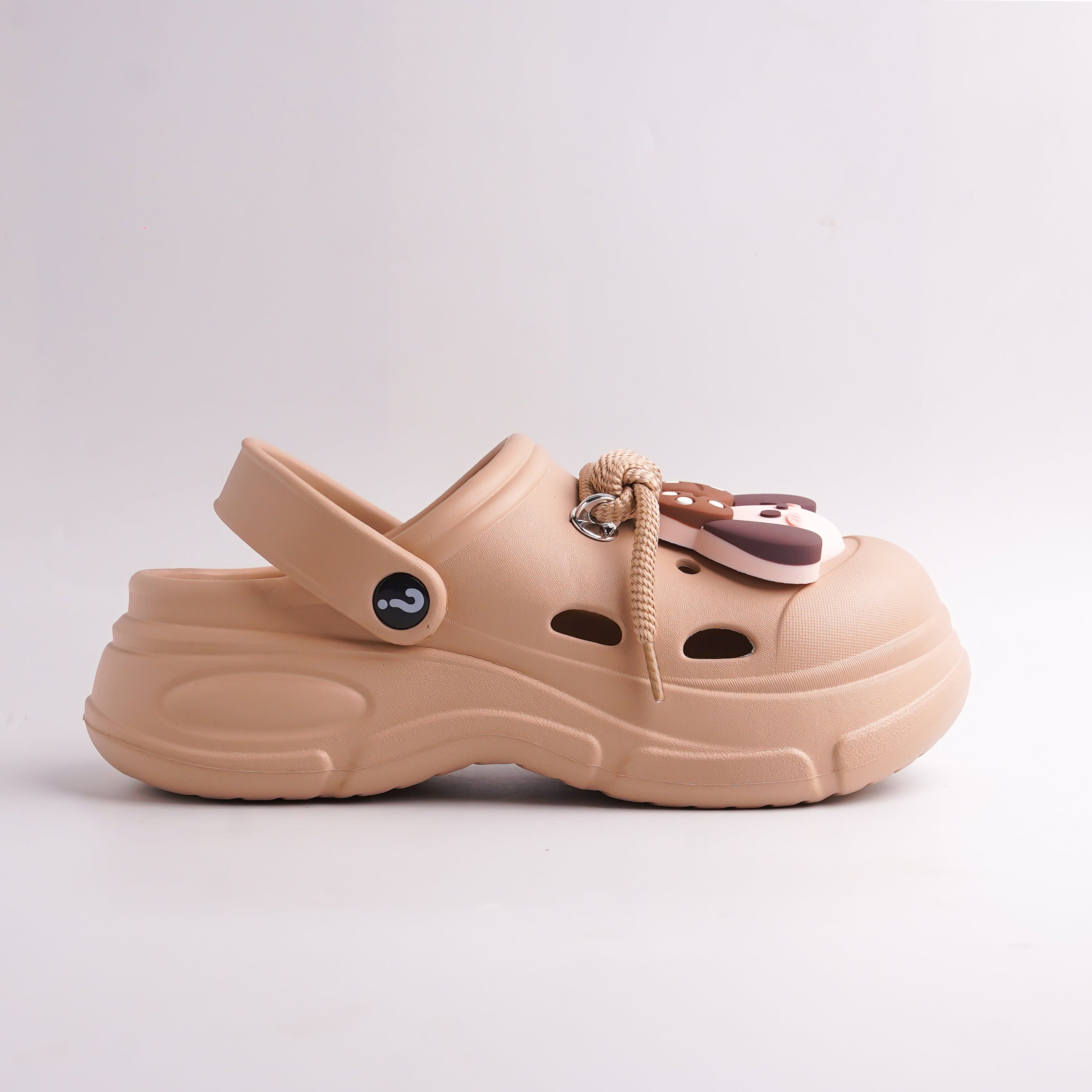 Side view of Tan Platform Clog showing the chunky sole, back strap with question mark logo, and charm detail.