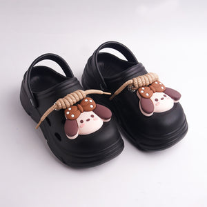 Black sandals with cartoon dog decorations on a white background