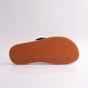 Bottom view of Black Toe-Loop Sandal showing the textured anti-slip brown sole.