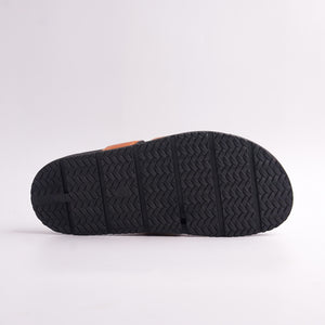 Black anti-slip chevron tread pattern on the sole of Tan Cut-Out Slides, bottom view.