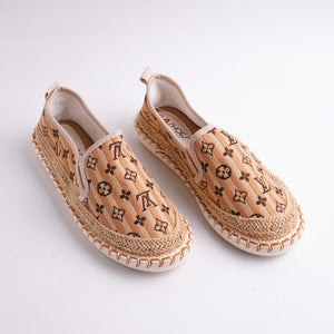 Pair of espadrilles with a brand logo on a white background