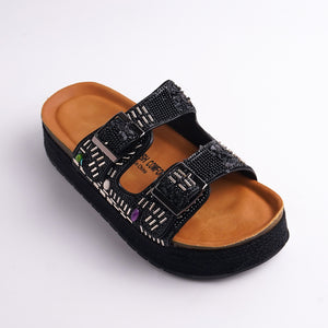 Black sandal with brown sole on a white background
