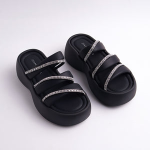 Black sandals with rhinestone straps on a white background