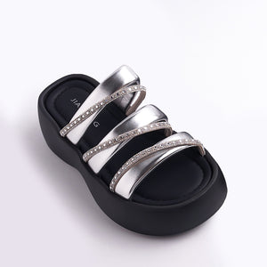 Black sandal with silver straps on a white background