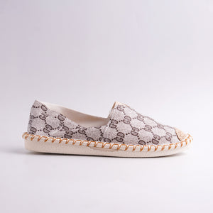 Single shoe with patterned top and woven sole on a light gray background