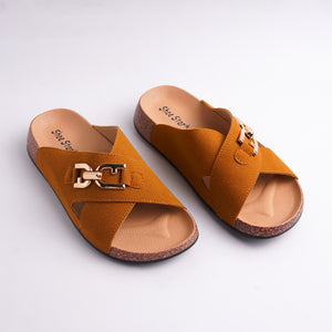 Pair of mustard yellow sandals with gold buckle on a light gray background