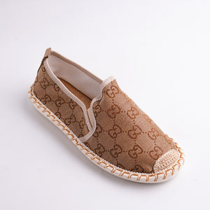 Brown slip-on shoe with pattern on a white background