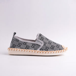 Gray slip-on shoe with a pattern on a light gray background