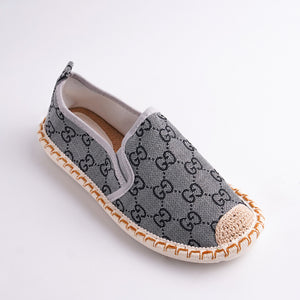 Gray espadrille shoe with a pattern on a white background