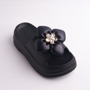 Close-up of Black Platform Slide showing the rhinestone flower embellishment.
