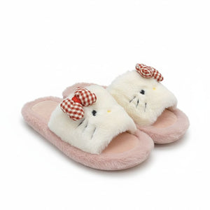 Pair of pink slippers with fluffy white cat face design on a white background