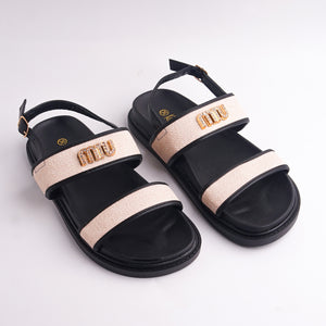 Black sandal with beige strap on a light gray background