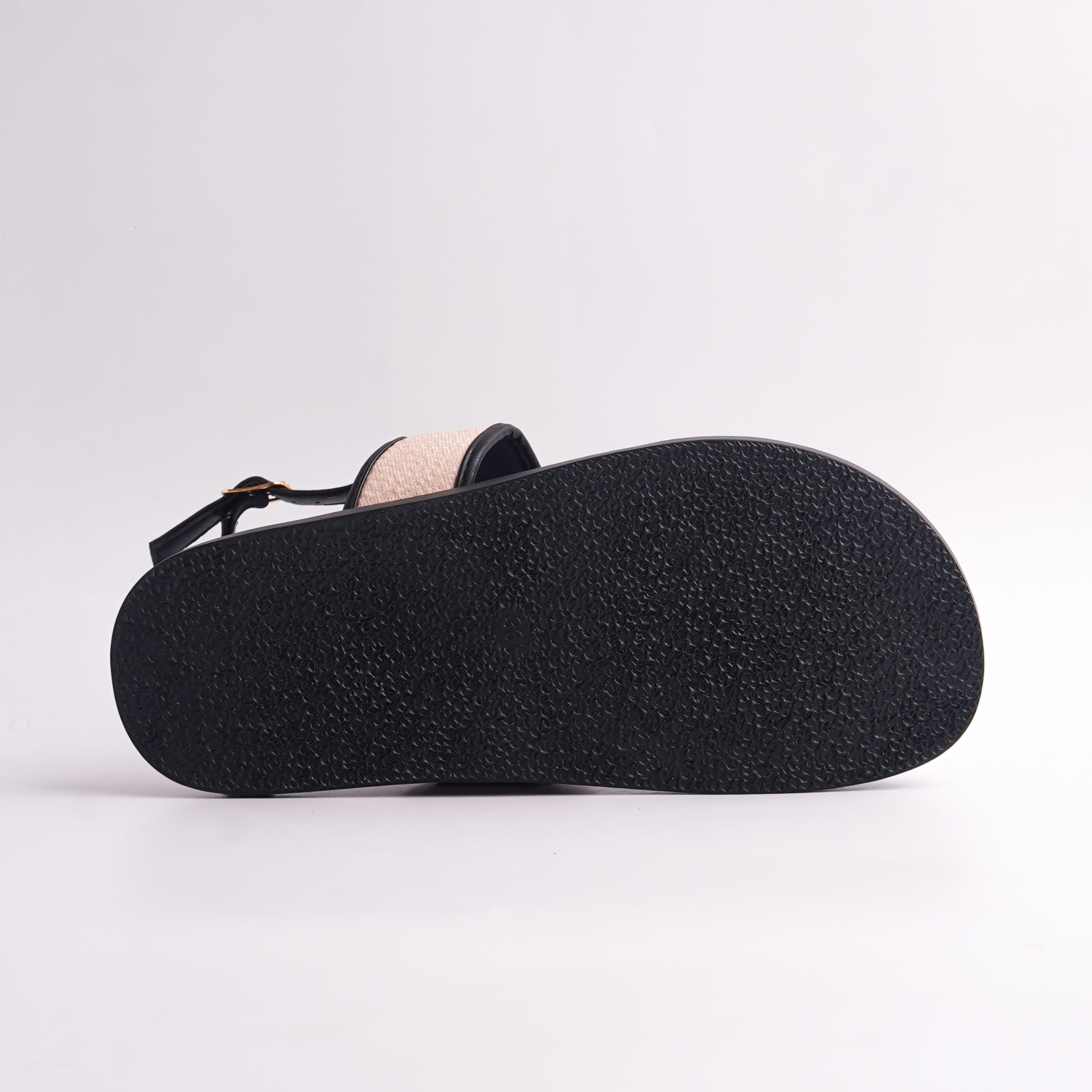 Close-up of a brown sandal sole on a light gray background