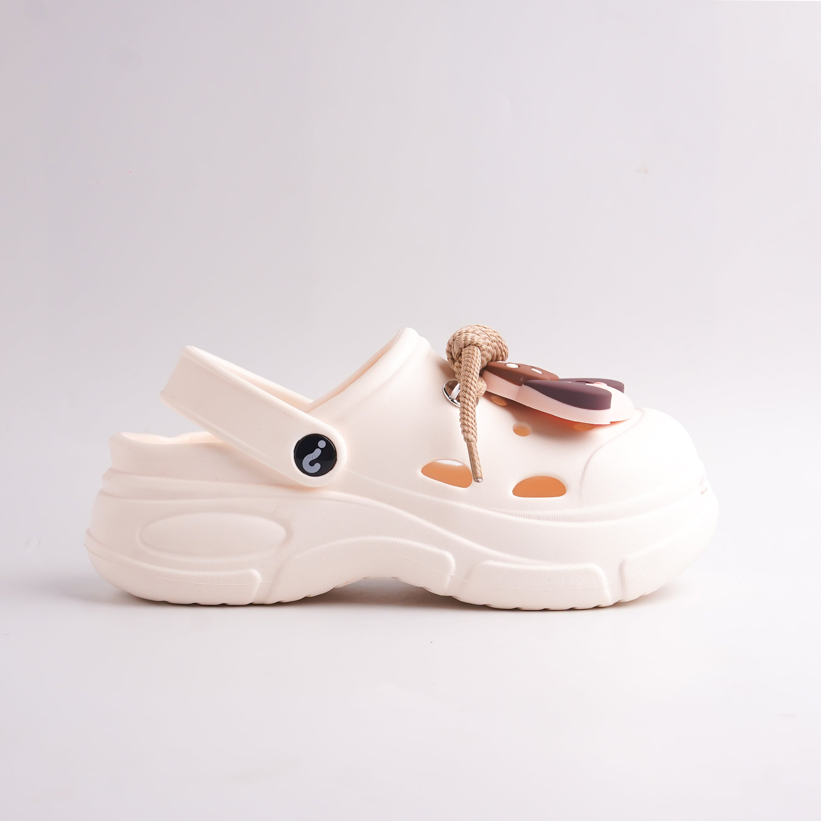 White sandal with brown accents on a light gray background