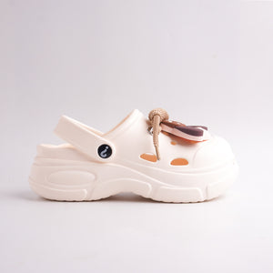 White sandal with brown accents on a light gray background