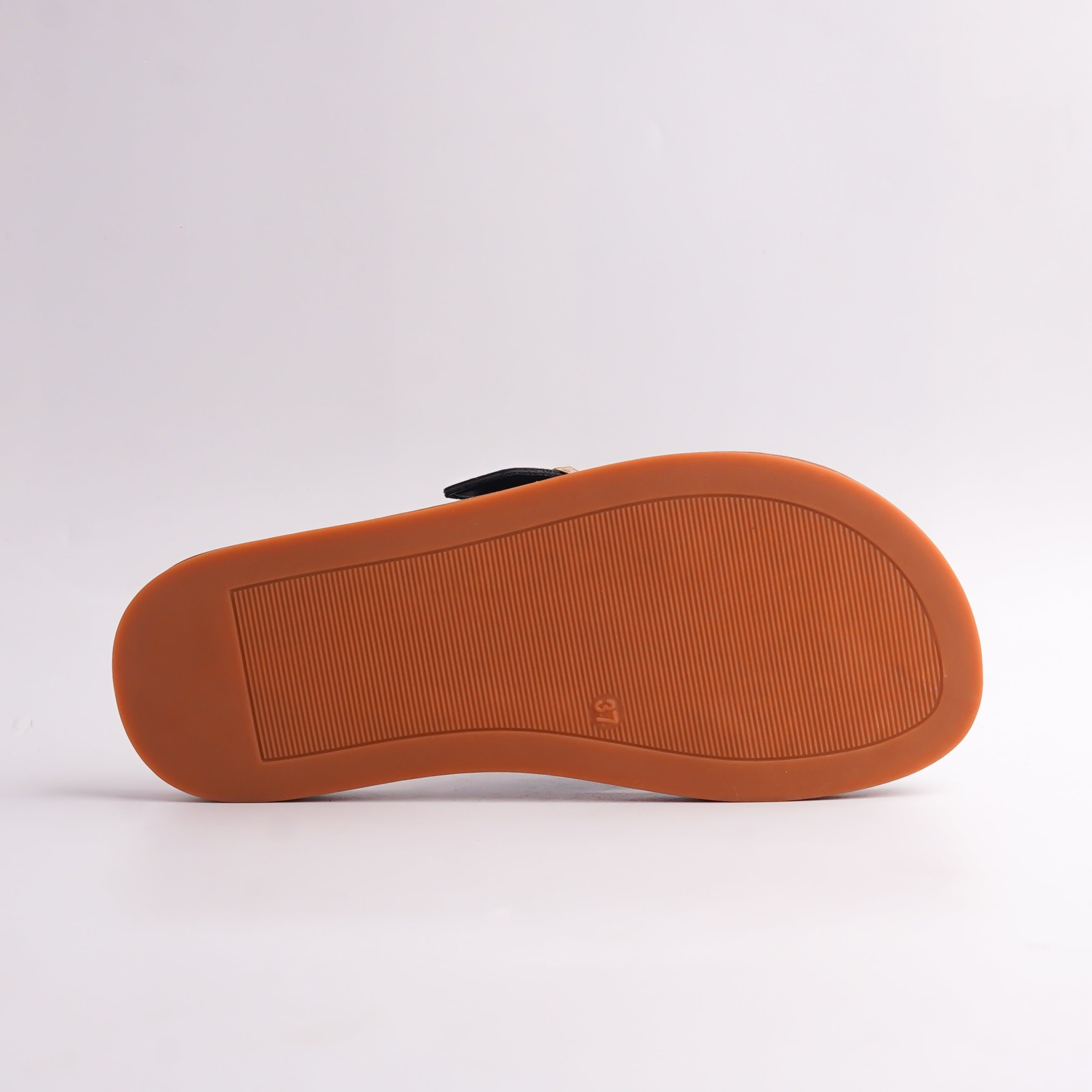 Bottom view of Black Toe-Loop Sandal showing the textured anti-slip brown sole.