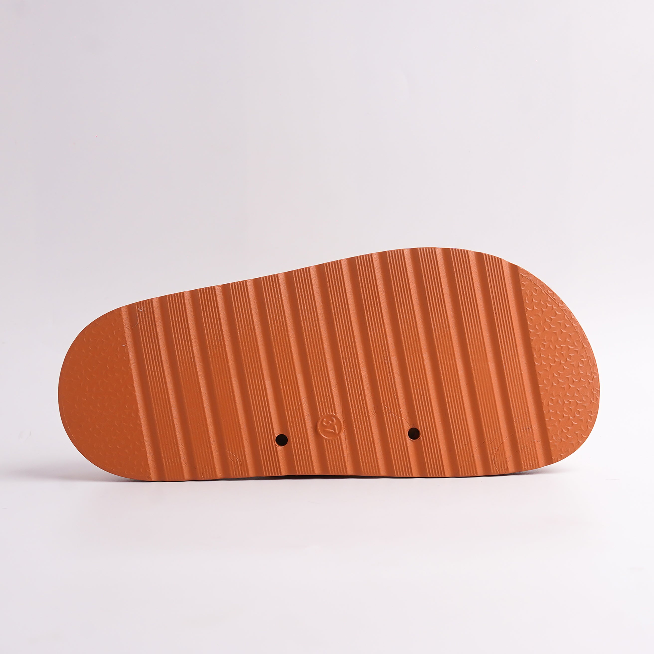 Ridged, anti-slip sole of Terracotta Chunky Slides, bottom view.