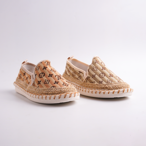 Pair of espadrilles with patterned design on a light gray background