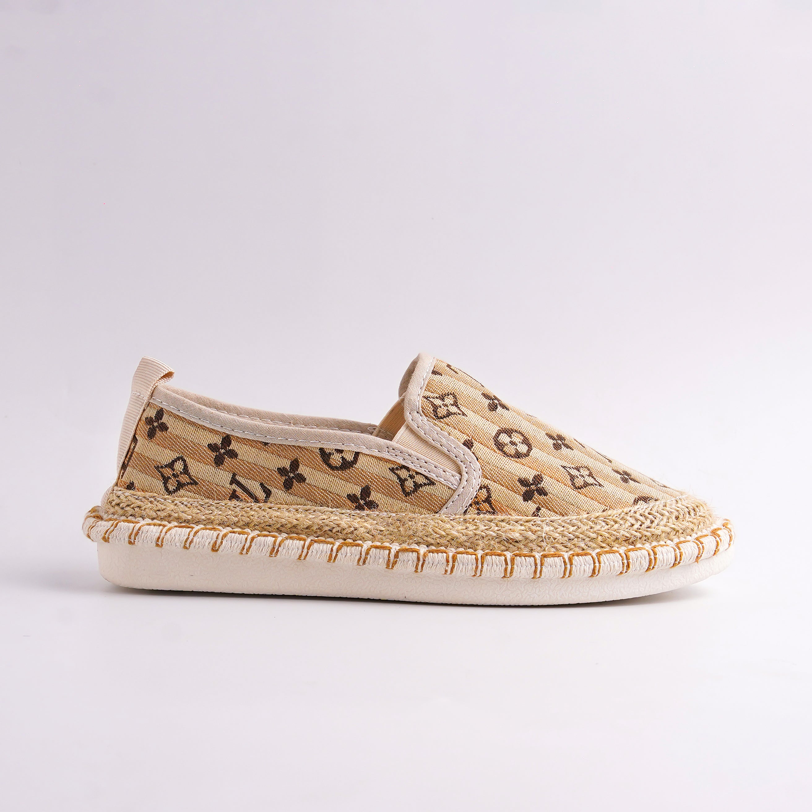 Beige slip-on shoe with patterned design on a light gray background