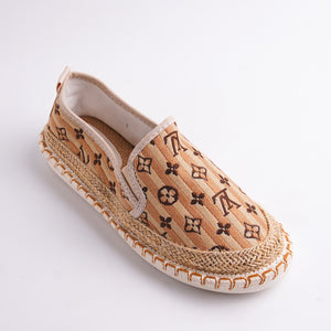 Espadrille shoe with patterned fabric and jute sole on a white background