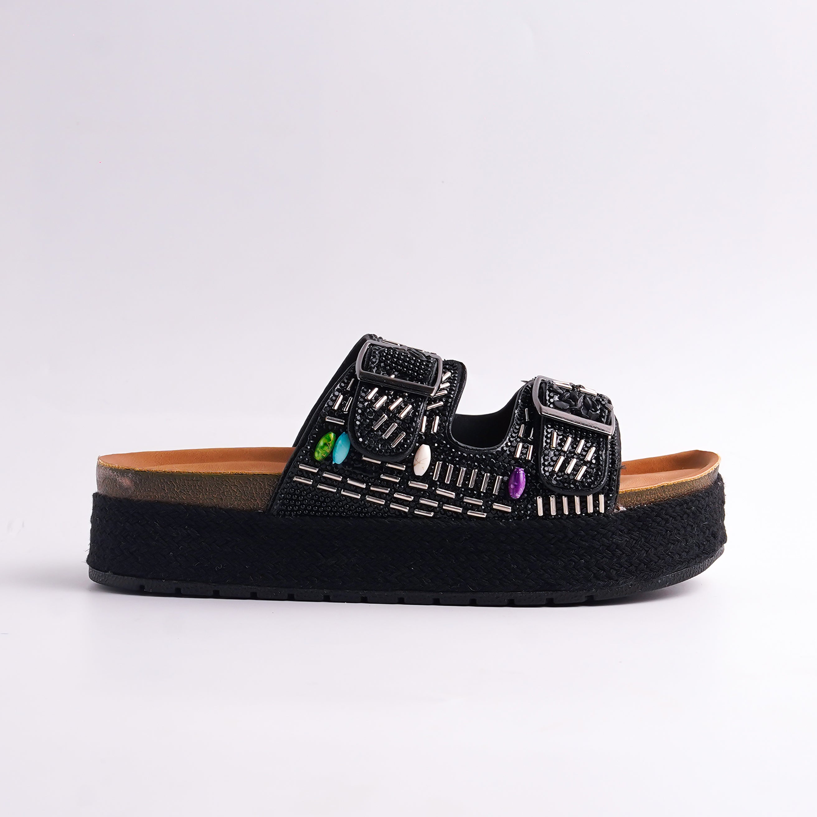 Black sandal with decorative elements on a white background