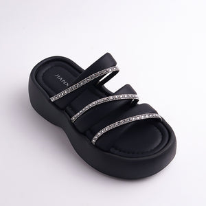 Black sandal with rhinestone straps on a white background