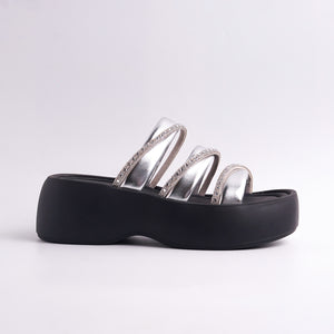 Black sandal with silver straps on a white background