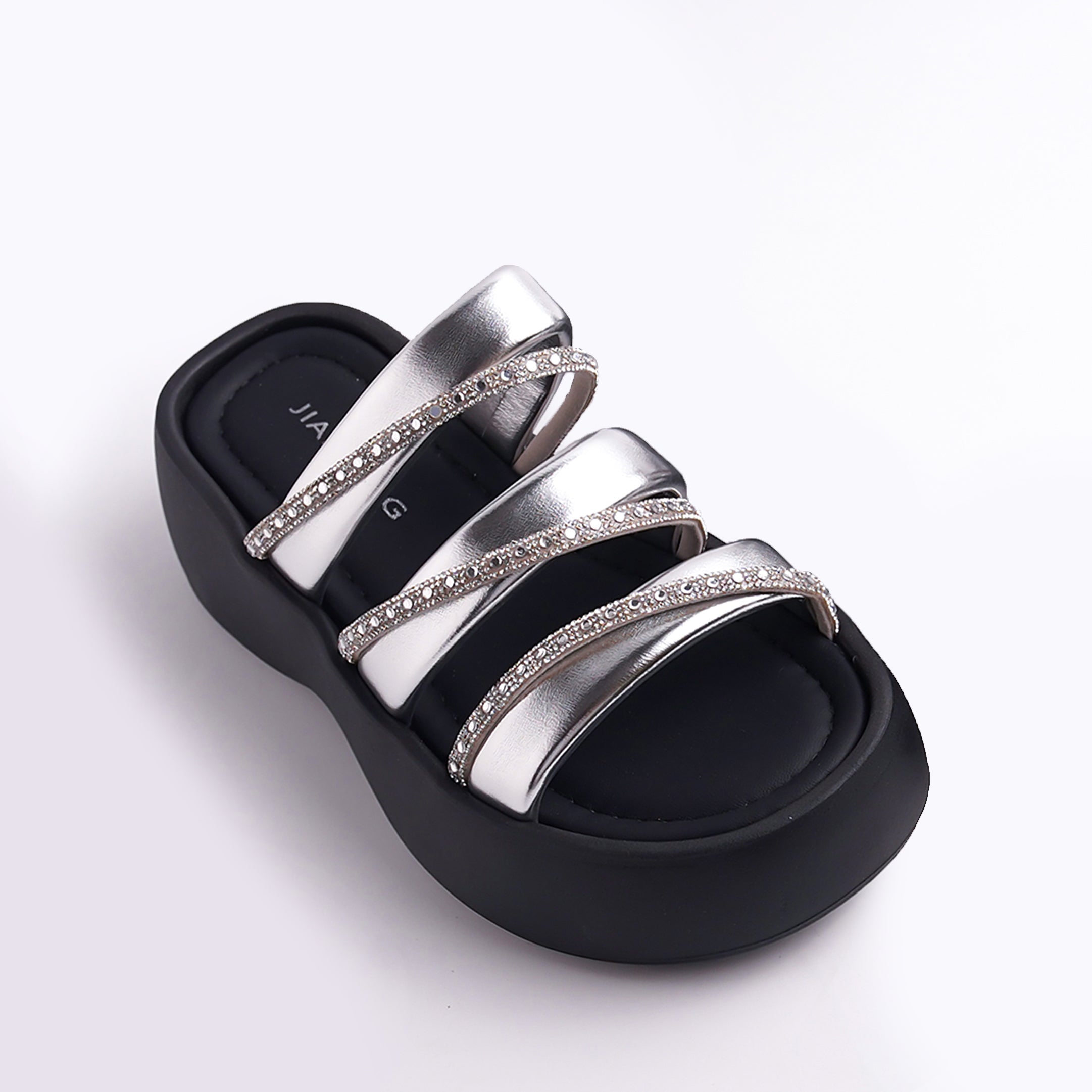 Black sandal with silver straps on a white background