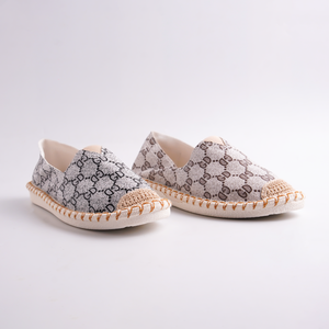 Pair of patterned espadrilles on a light gray background