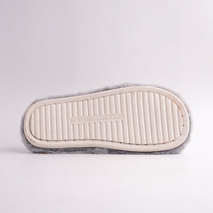 backside view of Gray Faux Fur Slides with white embroidered 'HOME WARM' cross-straps, cozy slippers.