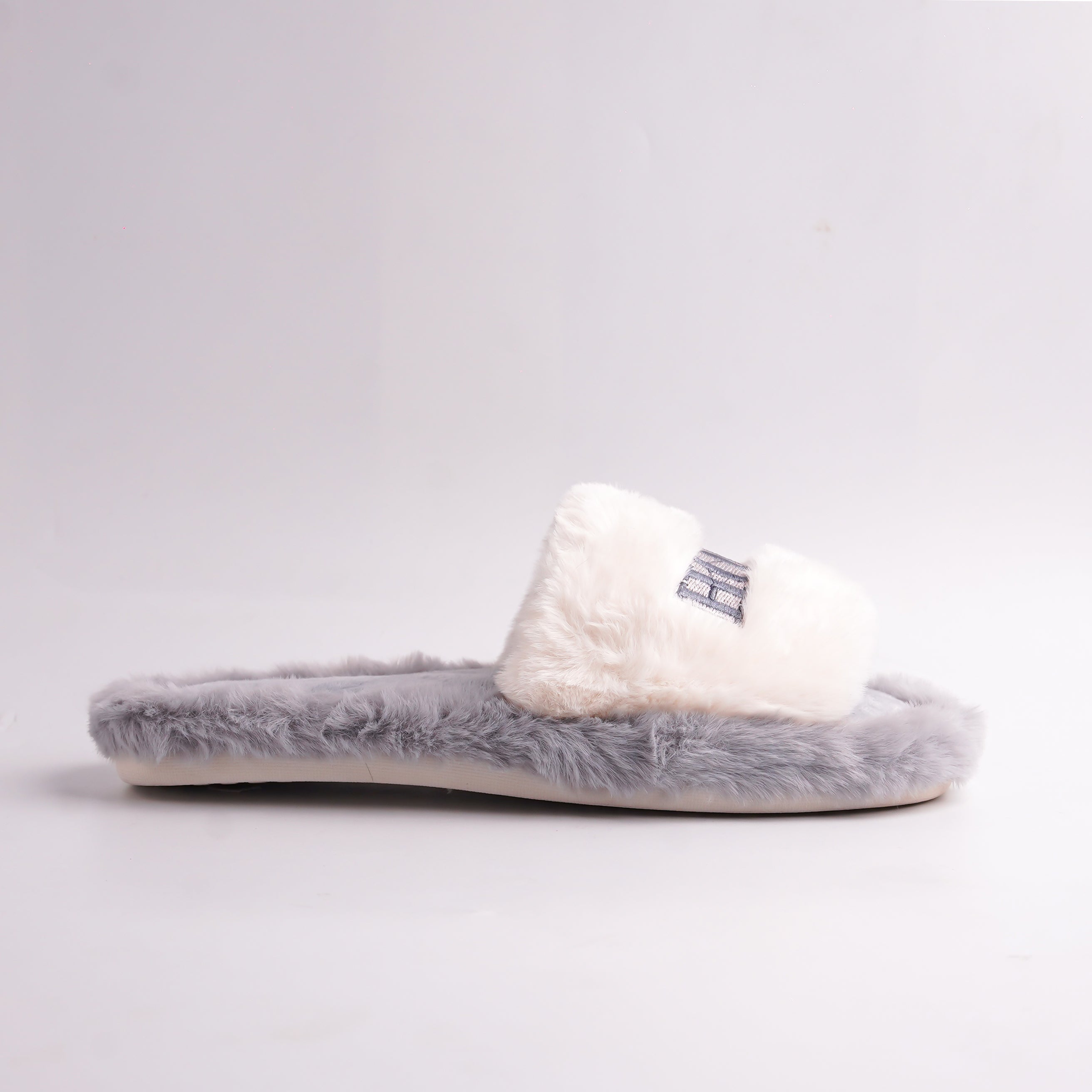 White ridged anti-slip sole of Gray Faux Fur Slides, bottom view, durable indoor sole.