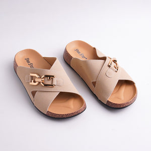 Pair of beige sandals with gold buckles on a light gray background