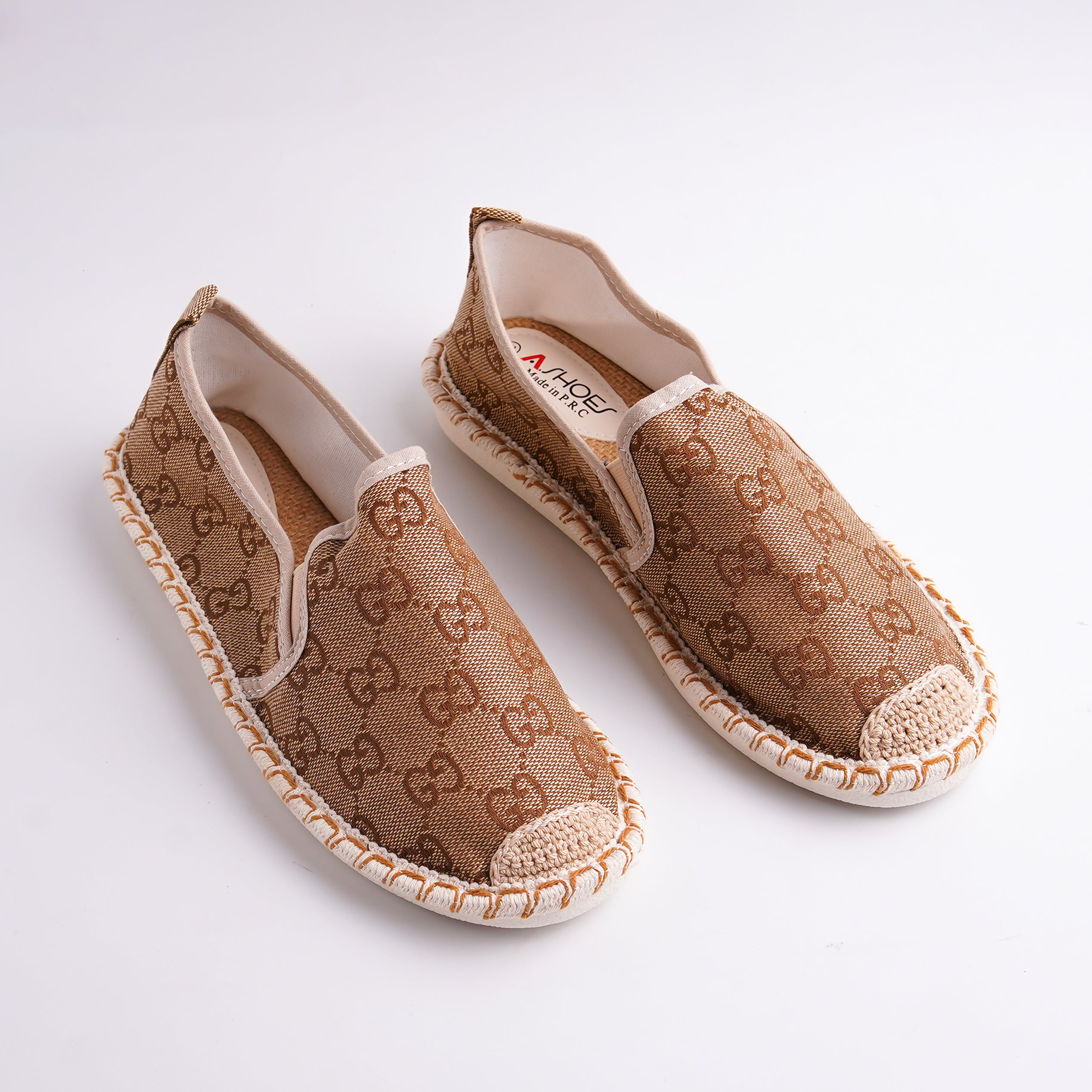 Pair of brown patterned shoes on a white background