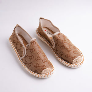 Pair of brown patterned shoes on a white background