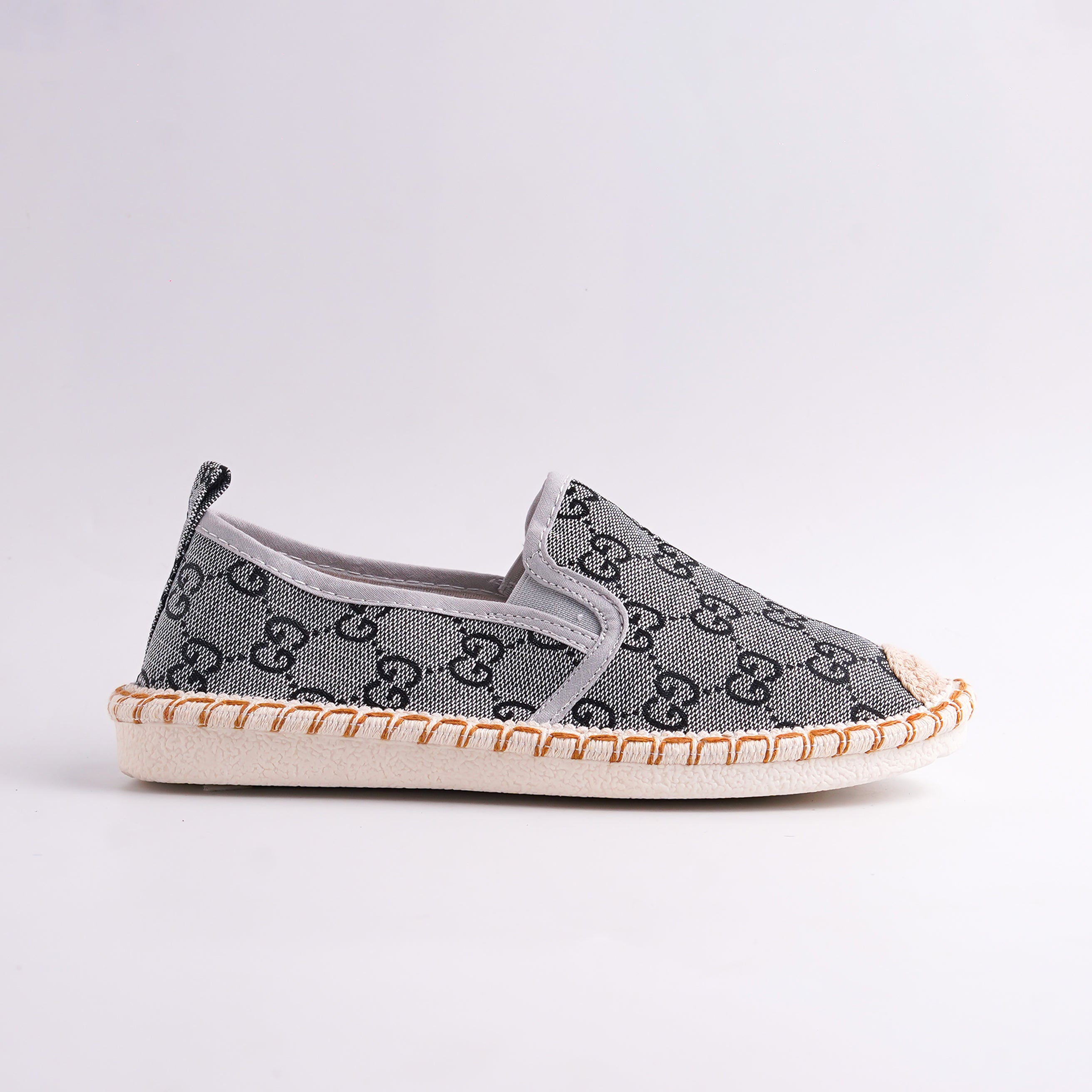 Gray slip-on shoe with a pattern on a light gray background