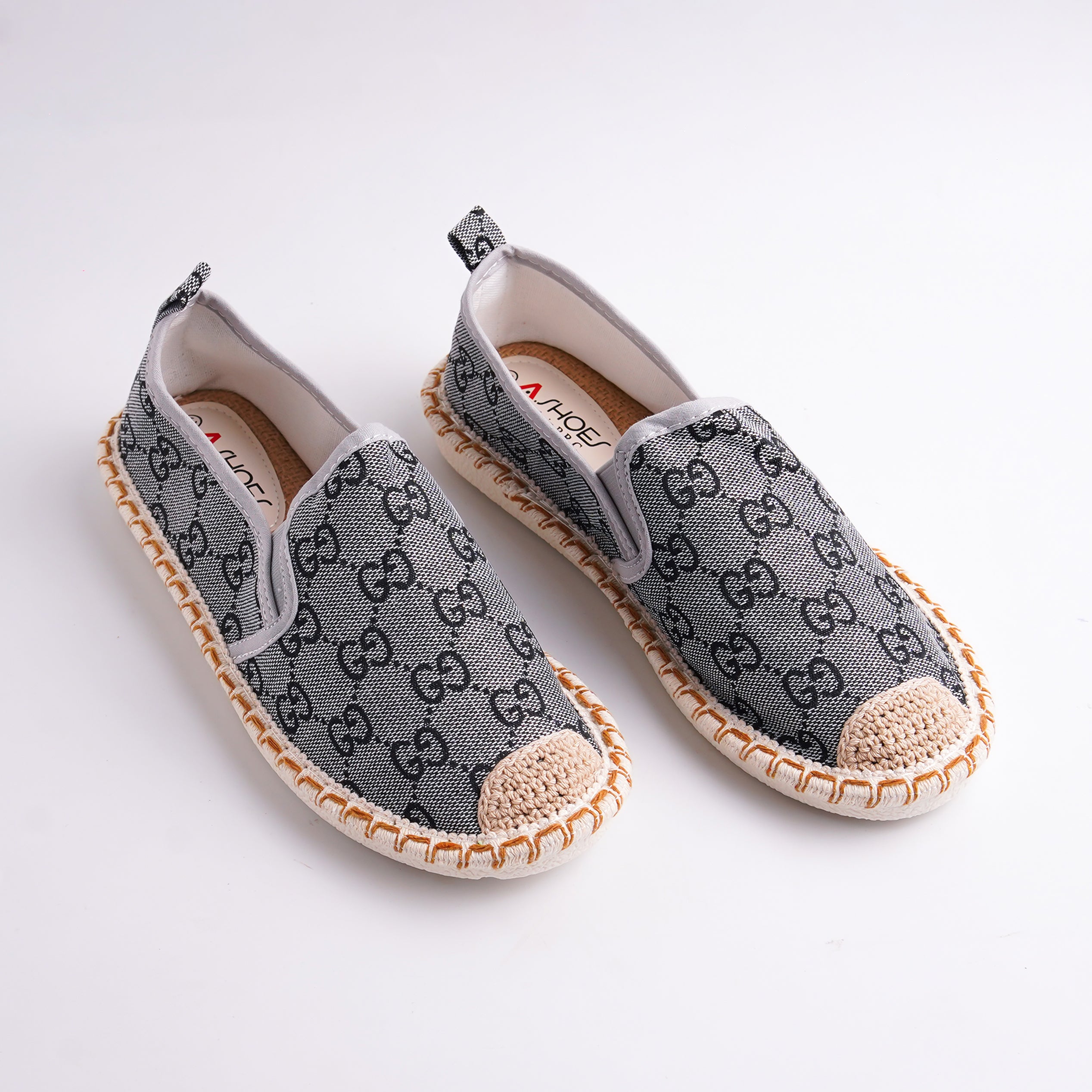 Pair of gray slip-on shoes with a pattern on a white background