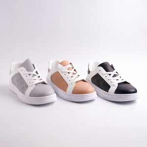 Three sneakers in gray, brown, and black on a light gray background