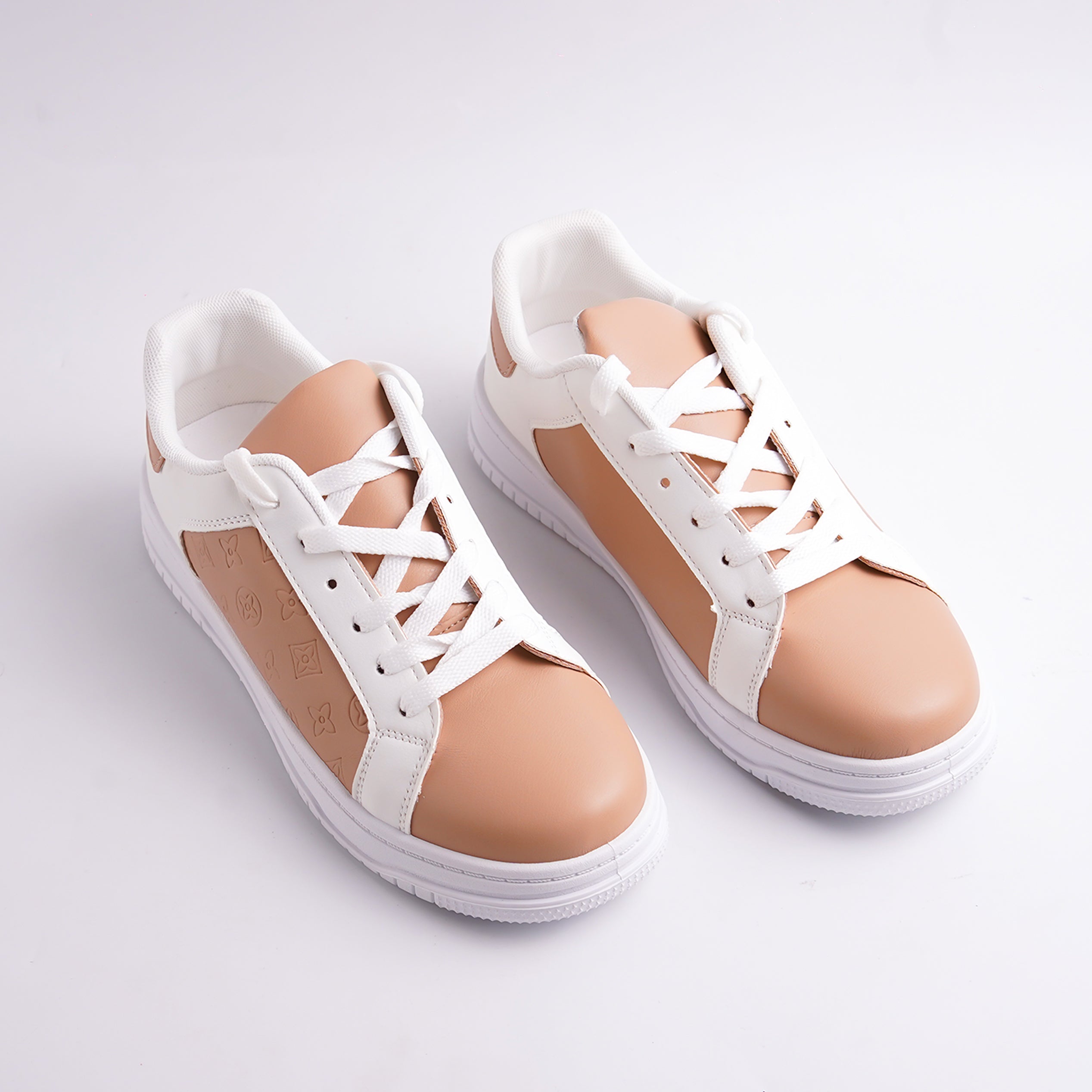 White sneakers with beige accents on a light gray background