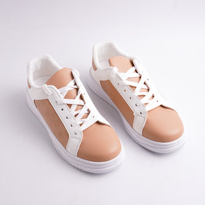 White sneakers with beige accents on a light gray background