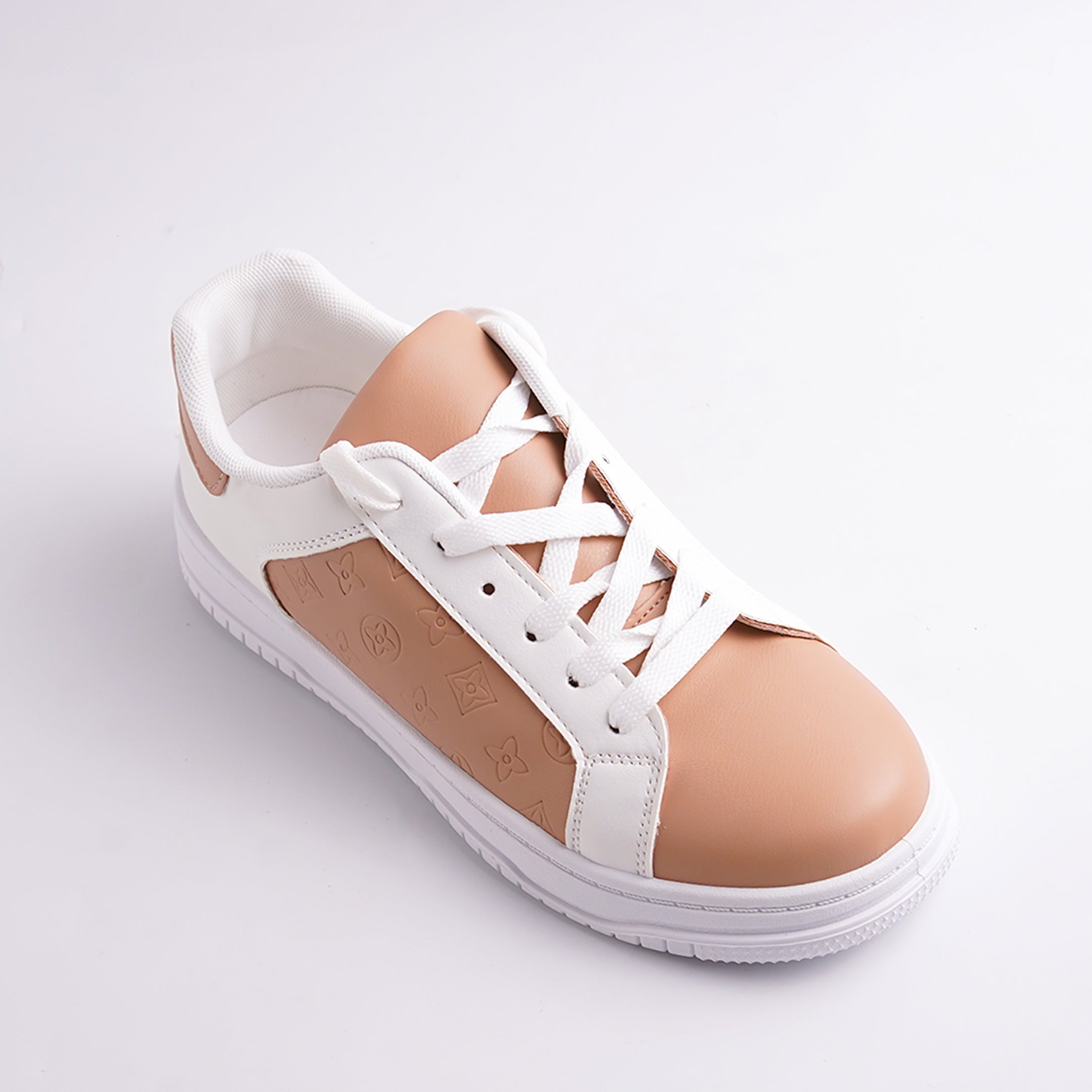 White sneaker with a tan patch on a light gray background