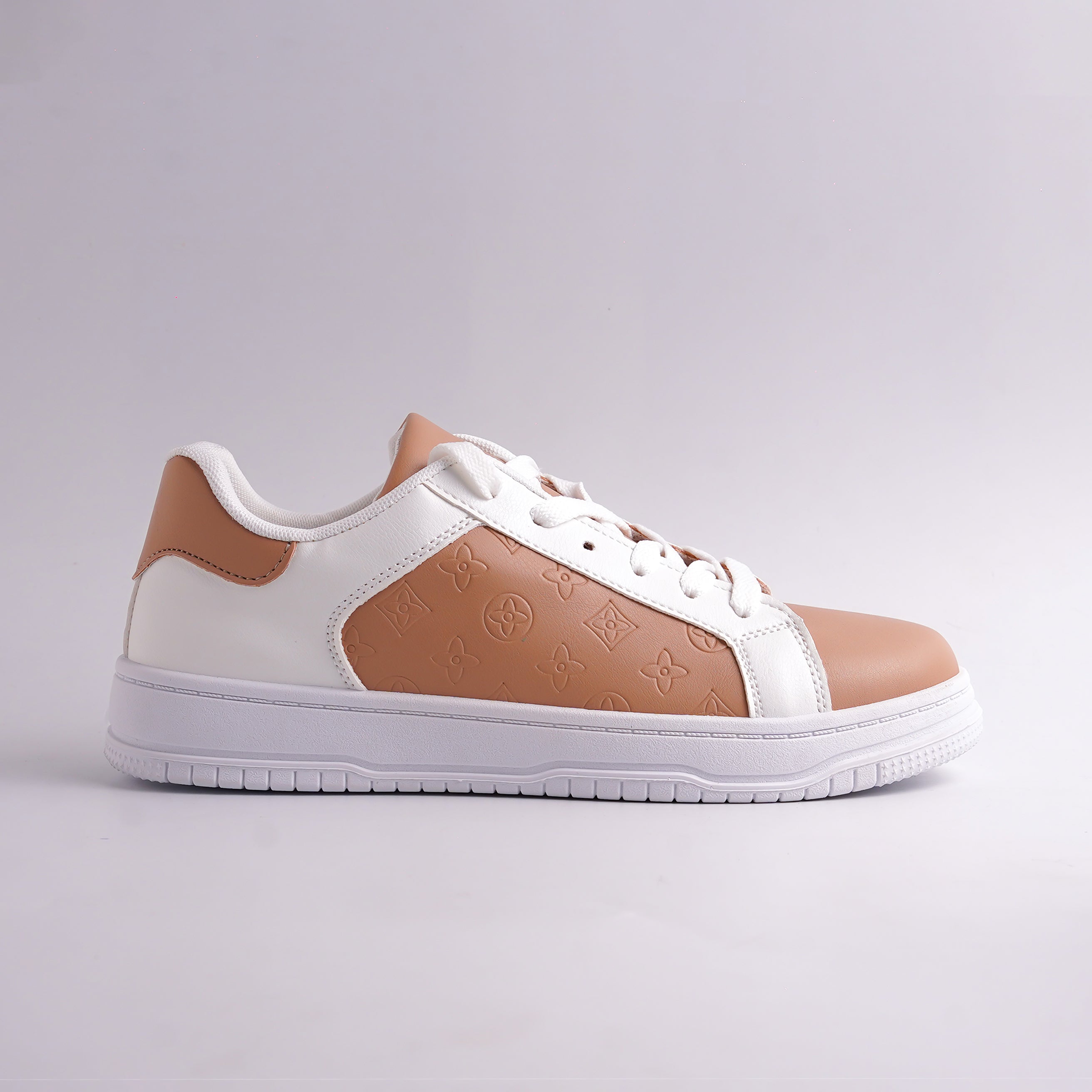 White and brown sneaker on a light gray background