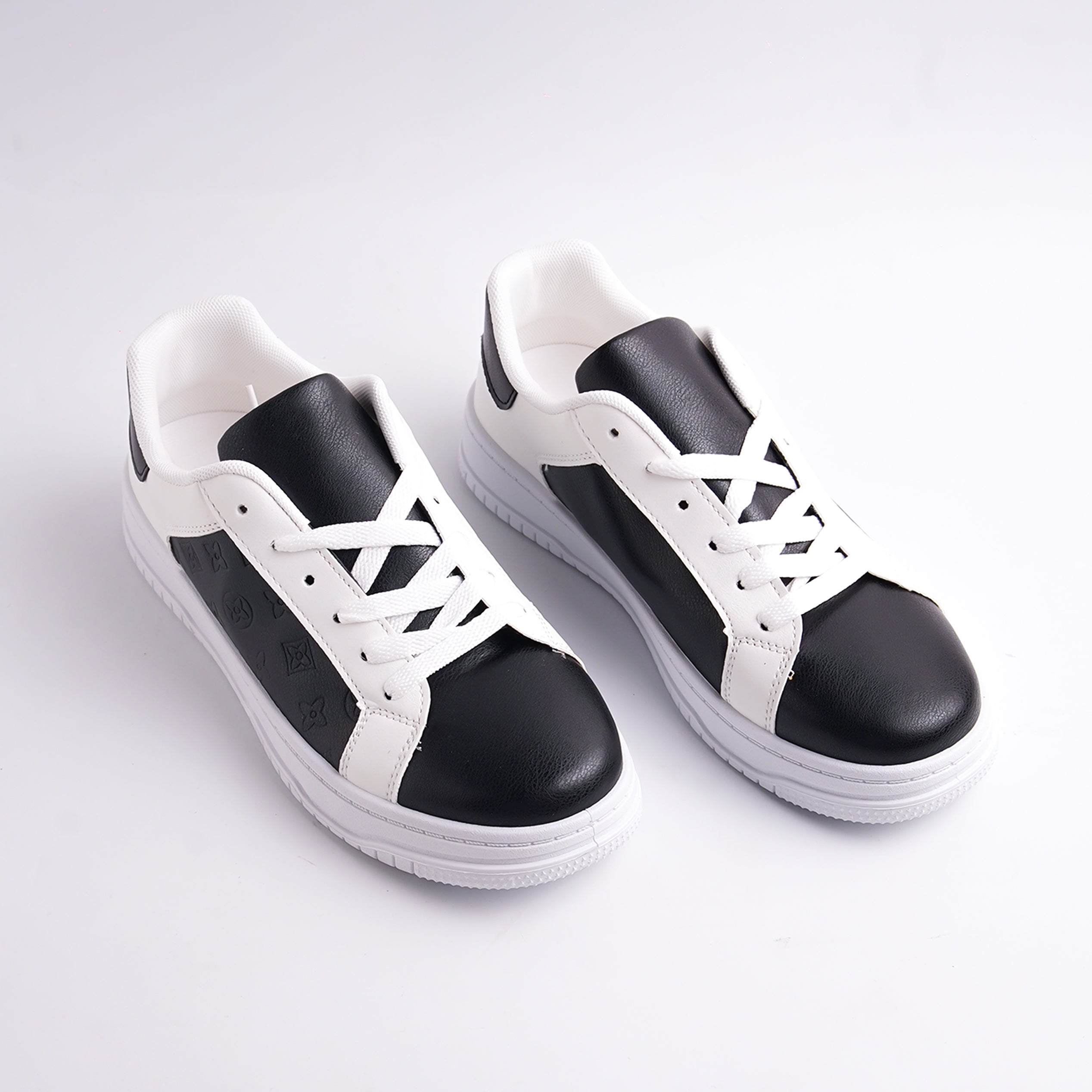 Black and white sneakers on a light gray background