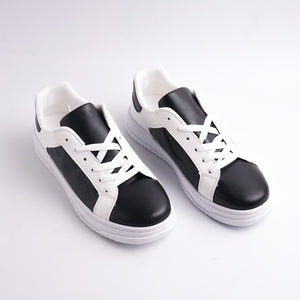 Black and white sneakers on a light gray background