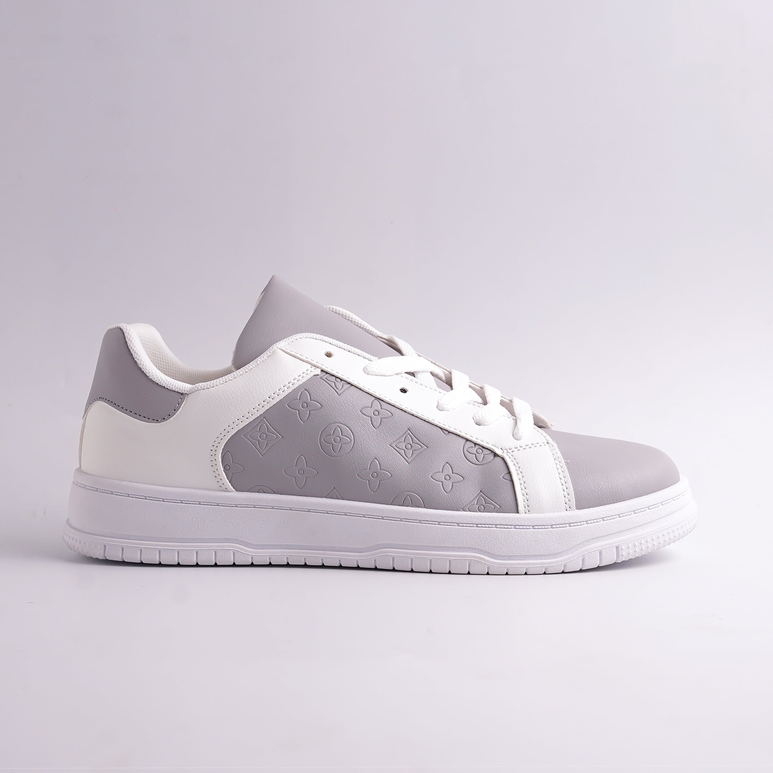 Gray and white sneaker with brand logo on a light gray background