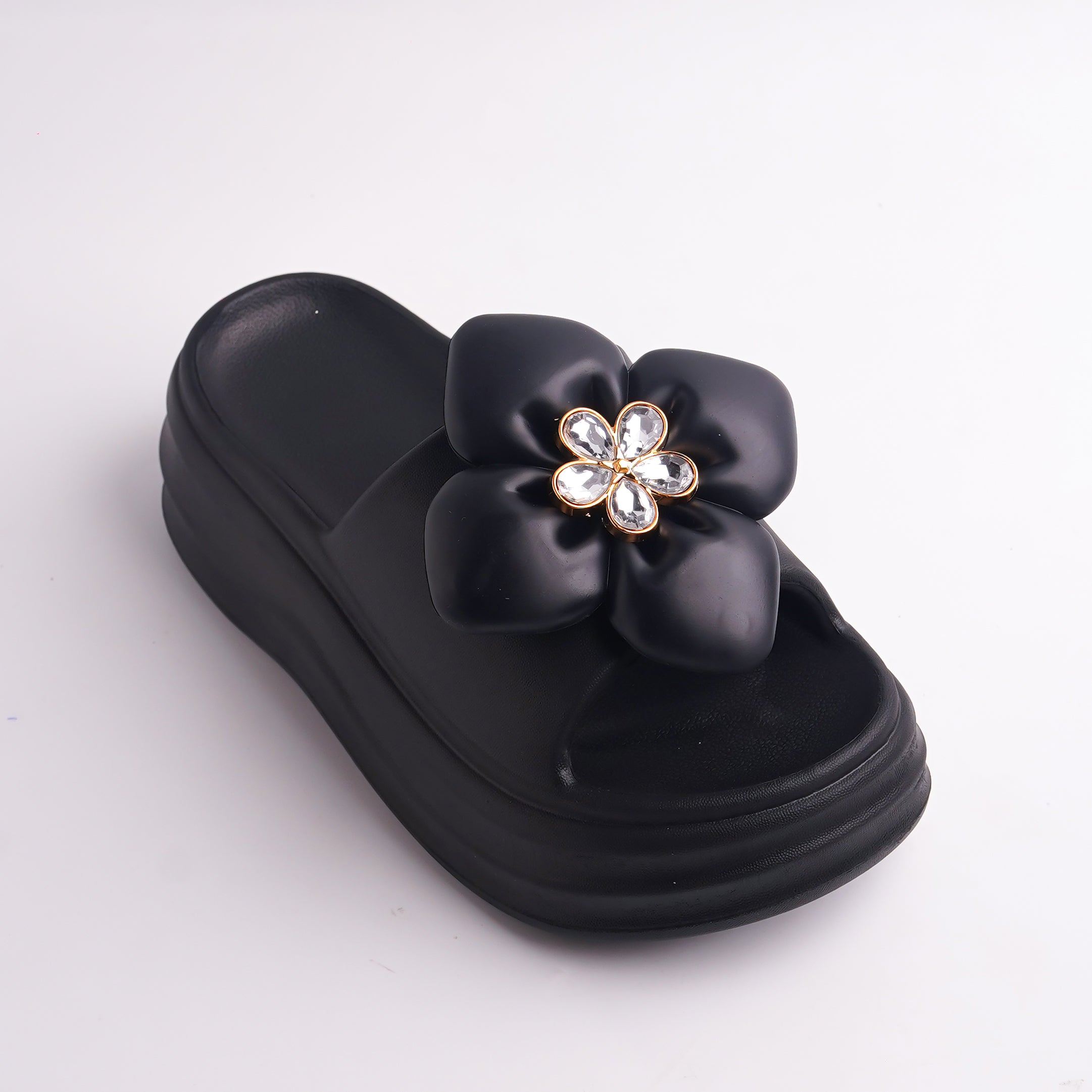 Close-up of Black Platform Slide showing the rhinestone flower embellishment.