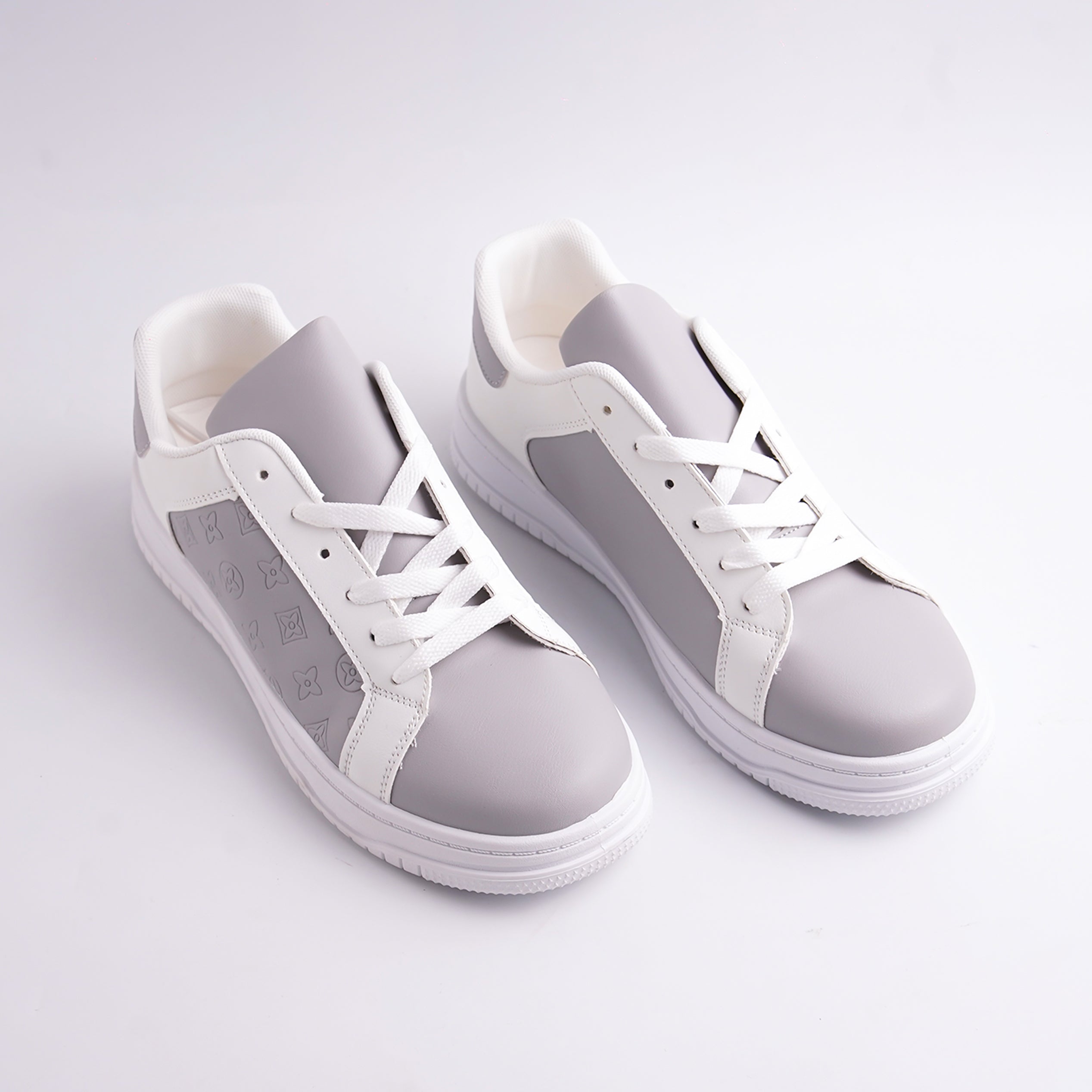 White and gray sneakers on a light gray background
