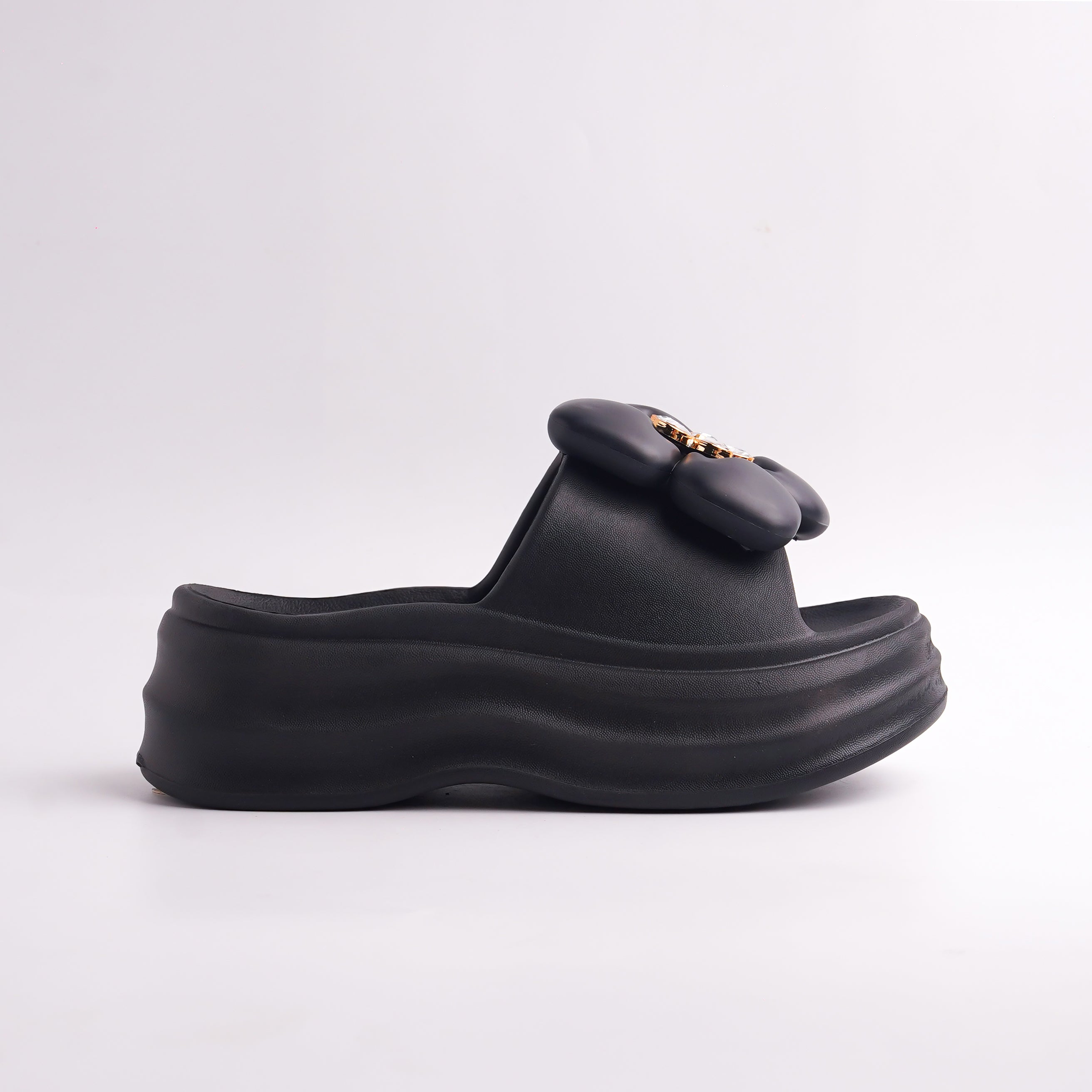Side profile of the Black Platform Flower Slide showing the chunky sole and floral detail.